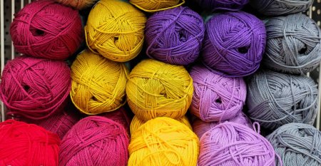 Photo for Colorful of Yarn Balls Wool in a Fabric Shop. Background from colored acrylic yarn. Skeins of thread close-up. Materials for needlework, for knitting and crocheting. - Royalty Free Image