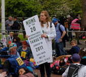 LONDON, UK - April 22, 2023. Extinction Rebellion demonstrators lay down on the pavement during a peaceful climate change protest. International Mother Earth Day. magic mug #708188696