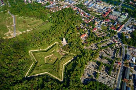 Aerial view of Prusy Fort in Nysa city on clear day, Star-shaped historical military fortress surrounded by lush greenery and the town in background. Tourist attraction in Poland