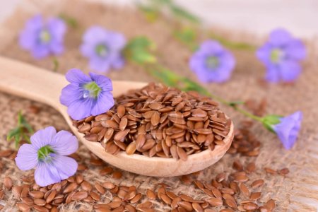 Photo for Flax seeds on a wooden spoon on table - Royalty Free Image