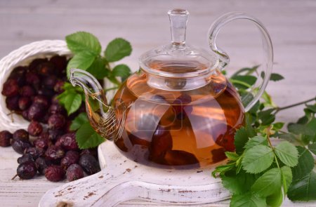 Photo for Tea from rose hips in a transparent teapot. The concept of medicinal drinks. - Royalty Free Image