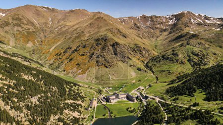 ancient monastery Vall De Nuria, drone view. Drone flies over the mountains towards the monastery and the lake. Panoramic view of the territory of the monastery Vall De Nuria with a beautiful lake