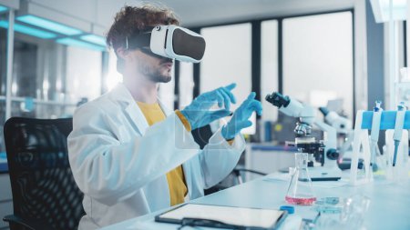 Photo for Futuristic Medical Research Laboratory: Modern Scientist Wearing Virtual Reality Headset, Does Augmented Reality Research Using Smart Gestures. Big Data AI Biotechnology Research in Progress - Royalty Free Image