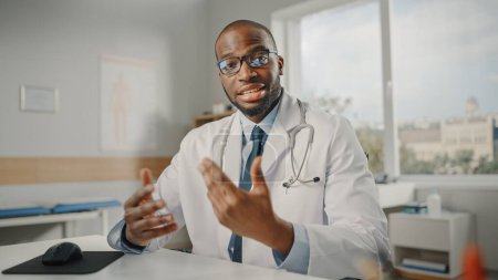 Photo for Doctor's Online POV Medical Consultation: African American Physician is Making a Video Call with a Patient. Black Health Care Professional Giving Advice, Explaining Test Results. Point of View Shot - Royalty Free Image