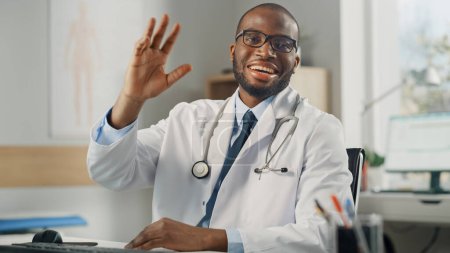 Téléchargez les photos : Consultation médicale POV en ligne du médecin : Le médecin afro-américain fait un appel vidéo avec un patient. Professionnel de la santé noir Donner des conseils, faire un geste d'accueil. Point de vue prise de vue - en image libre de droit