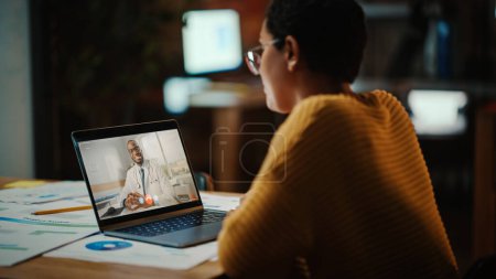Photo for Beautiful Multiethnic Latina Manager is Making Video Call to His Doctor on Laptop in a Creative Office Environment. Man is Talking to His Medical Consultant Over a Live Camera, Asking about Health. - Royalty Free Image