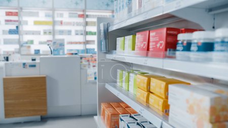 Photo for Modern Pharmacy Drugstore with Shelves full of Packages with Modern Medicine, Pill Drugs, Boxes with Vitamins and Supplements, Health Care and Beauty Products. Side View Shot - Royalty Free Image