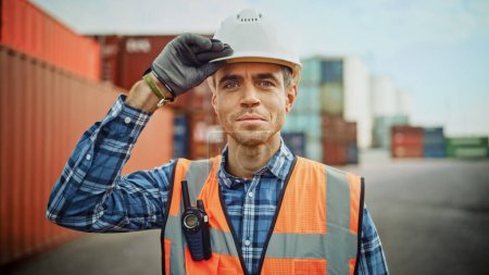 Photo for Smiling Portrait of a Handsome Caucasian Industrial Engineer in White Hard Hat, Orange High-Visibility Vest, Checkered Shirt and Work Gloves. Foreman or Supervisor Has a Two-Way Radio Attached. - Royalty Free Image