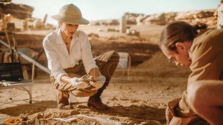 Photo for Archaeological Digging Site: Two Great Paleontologists Cleaning Newly Discovered of Dinosaur. Archeologists on Excavation Site Discover Fossil Remains of New Species Skeleton. Close-up Focus on Hands - Royalty Free Image