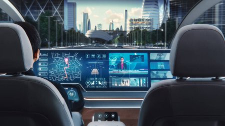 Photo for Futuristic Concept: Stylish Businessman Using Navigation App on an Augmented Reality Dashboard with Financial News Broadcast while Sitting in an Autonomous Self-Driving Zero-Emissions Electric Car. - Royalty Free Image