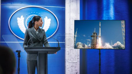 Photo for Organization Female Representative Speaking at Press Conference in Government Building about New Successful Space Rocket Lunch. Press Officer Delivering a Speech at Summit. - Royalty Free Image