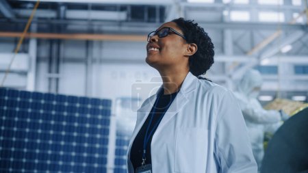 Photo for Brilliant Female Engineer Looking Around in Wonder at the Aerospace Satellite Manufacturing Facility. Young Talent Starting Her Career in World Top Science and Technology Space Exploration Program - Royalty Free Image
