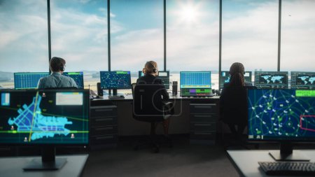 Equipo de Control de Tráfico Aéreo Diverso Trabajando en una Torre Moderna del Aeropuerto. La sala de oficina está llena de pantallas de computadora de escritorio con pantallas de navegación, datos de radar de vuelo de avión para controladores.