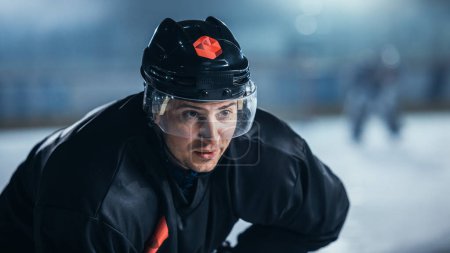 Ice Hockey Rink Arena: Confident Professional Player Ready for Faceoff and Match Start. Portrait of the Star Athlete, Determined to Win Championship, Ready to Hit that Goal. Portrait Shot