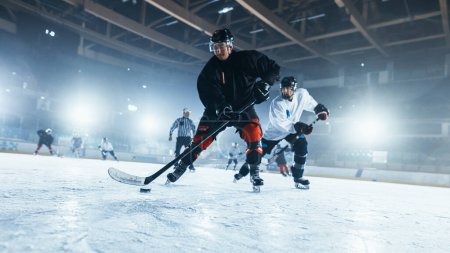 Photo for Ice Hockey Rink Arena: Professional Forward Player Masterfully Dribbles, Breaks Defense, Gives Perfect Pass and Riding On Camera. Strong Performance Teams Play. - Royalty Free Image