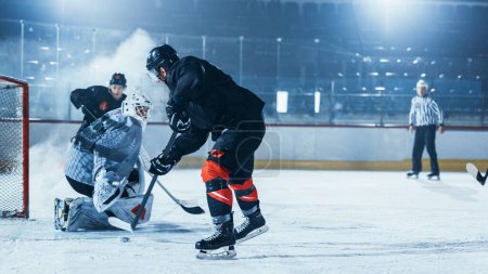 Photo for Ice Hockey Rink Arena: Goalie Against Forward Player who is Doing Slapshot, Shots Puck with Stick and Scores Goal. Forwarder against Goaltender on a World Hockey Championship. Tension Moment. - Royalty Free Image