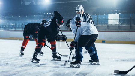 Ice Hockey Rink Arena Game Start: Two Players Brutal Face off, Sticks Ready, Referee Drops the Puck, Athletes fight for It. Intense Game Wide of Energy Competition, Speed. Sport Full of Emotions.
