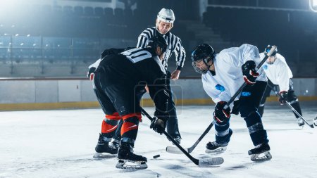 Ice Hockey Rink Arena Game Start: Two Players Brutal Face off, Sticks Ready, Referee Drops the Puck, Athletes fight for It. Intense Game Wide of Energy Competition, Speed. Sport Full of Emotions.