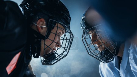 Ice Hockey Rink Arena Game Start: Two Professional Players Aggressive Face off, Sticks Ready. Intense Competitive Game Wide of Brutal Energy, Speed, Power, Professionalism, Skill. Close-up Shot.