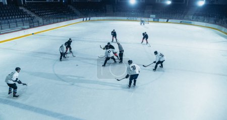 Ice Hockey Rink Arena: Great Team Attacks, Plays Pass Using Tactics and Creative Strategy. Player Masterful Dribbles. Beautiful Energetic Game from Team. High Angle Shot