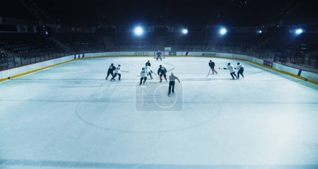 Ice Hockey Rink Arena: Great Team Attacks, Plays Pass Using Tactics and Creative Strategy. Player Masterful Dribbles. Beautiful Energetic Game from Team. High Angle Shot