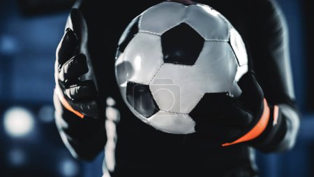 Photo for Professional Anonymous Soccer Goalkeeper Holding Fooltabll Ball. Star Footballer Goalie Accepting the Challenge, Determined, Confident in Winning Championship. Dramatic, Stylsih, Cinematic. - Royalty Free Image