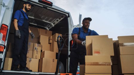 Outside of Logistics Retailer Warehouse With Manager Using Tablet Computer, Diverse Workers Loading Delivery Truck with Cardboard Boxes. Online Orders, Purchases, E-Commerce Goods.
