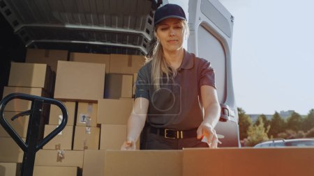 Photo for Outside of Logistics Retailer Warehouse With Manager Using Tablet Computer, Diverse Workers Loading Delivery Truck with Cardboard Boxes. Online Orders, Purchases, E-Commerce Goods. - Royalty Free Image