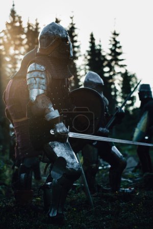 Photo for Epic Armies of Medieval Knights on Battlefield Clash, Plate Body Armored Warriors Fighting Swords in Battle. Bloody War and Savage Conquest. Historical Reenactment. Cinematic Shot - Royalty Free Image
