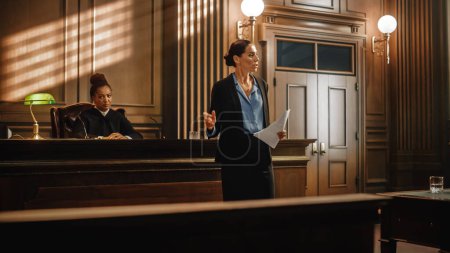 Photo for Court of Justice and Law Trial: Successful Female Public Defender Presenting the Case, Making Passionate Speech to Judge, Jury. Attorney Lawyer Protecting Client with Closing Not Guilty Arguments. - Royalty Free Image