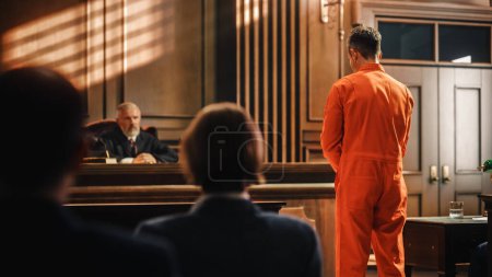 Photo for Court of Law and Justice Trial Proceedings: Law Offender in Orange Jumpsuit is Questioned and Giving Testimony to Judge, Jury. Criminal Denying Charges, Pleading, Inmate Denied Parole. - Royalty Free Image