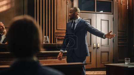 Court of Law Trial in Session: Portrait of Charismatic Male Public Defender Making Touching, Passionate Speech to Judge and Jury. Attorney Lawyer Protecting Client, Presenting Case.