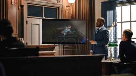 Court of Law Trial in Session: Portrait of Charismatic Male Public Defender Showing Dead Man on TV Screen to Judge and Jury. Attorney Lawyer Protecting Client, Presenting Case.