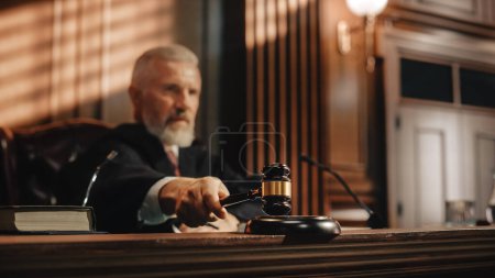 Photo for Court of Law and Justice Trial Session: Imparcial Honorable Judge Pronouncing Sentence, striking Gavel. Focus on Mallet, Hammer. Cinematic Shot of Dramatic Not Guilty Verdict. - Royalty Free Image