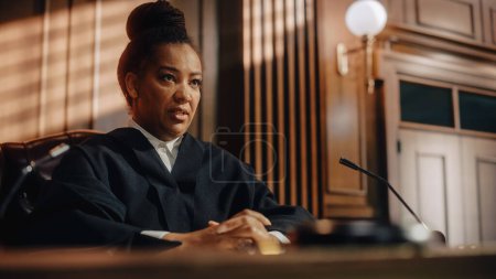 Court of Law Trial in Session: Portrait of Honorable Female Judge Reading Decision. Presiding Justice Pronouncing Sentence. Guilty, Not Guilty Verdict Judgment. Medium Portrait Shot