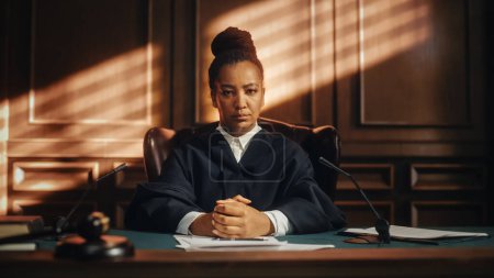 Photo for Cinematic Court of Law Trial: Portrait of Impartial Thoughtful Female Judge Looking at Camera. Wise, Incorruptible, Fair Justice Doing Her Job Professionally, Sentencing Criminals, Protecting Innocent - Royalty Free Image