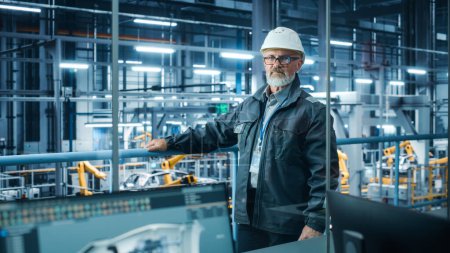 Photo for Car Factory: Confident Male Automotive Engineer Wearing Hard Hat, Looking at Camera. Technician Monitoring Equipment Production. Automated Robot Arm Assembly Line Manufacturing Electric Vehicles - Royalty Free Image