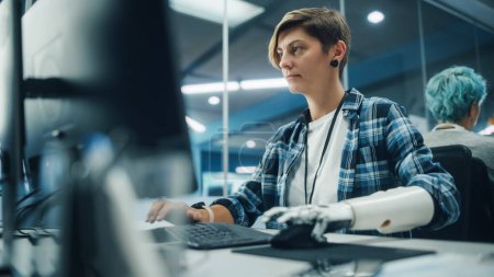 Photo for Diverse Body Positive Office: Portrait of Motivated Woman with Disability Using Prosthetic Arm to Work on Computer. Brave Professional with Futuristic Body Powered Myoelectric Bionic Hand - Royalty Free Image