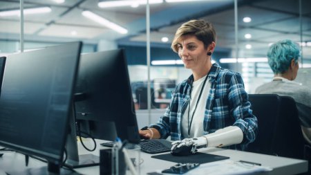 Photo for Diverse Body Positive Office: Portrait of Motivated Woman with Disability Using Prosthetic Arm to Work on Computer. Professional with Advanced Thought Controlled Body Powered Myoelectric Bionic Hand - Royalty Free Image