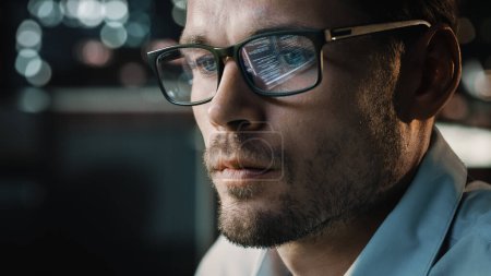 Photo for Portrait of Handsome Startup Digital Entrepreneur Working on Computer, Line of Code Reflecting in Glasses. Developer Working on Innovative e-Commerce Application using AI Algorithm to use Big Data - Royalty Free Image