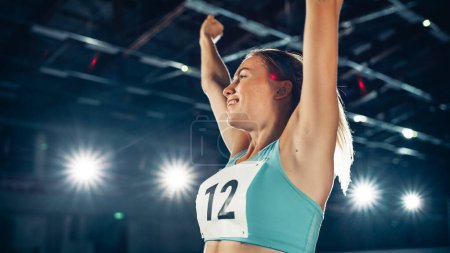 Photo for Portrait of Professional Female Athlete on Stadium Happily Celebrating World Record with Raised Arms on Sports Championship. Determination, Effort, Motivation, Inspiration are the Key of Success Story - Royalty Free Image