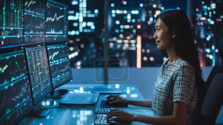 Photo for Portrait of a Financial Analyst Working on Computer with Multi-Monitor Workstation with Real-Time Stocks, Commodities and Exchange Market Charts. Businesswoman at Work in Investment Broker Agency. - Royalty Free Image