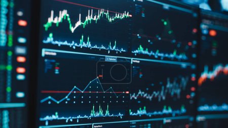 Photo for Close Up Shot of a Computer Monitor Screen with Real-Time Stocks, Commodities and Exchange Market Charts and Tickers on a Multi-Display Workstation in a Financial Business Office. - Royalty Free Image