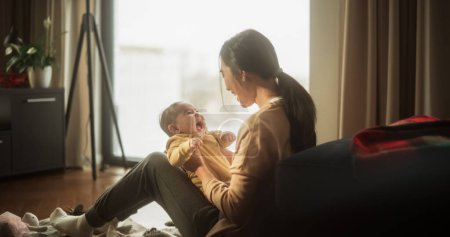 Photo for Mother and Baby Bonding Moment: Authentic Shot of an Asian Woman New to Motherhood Playing with her Cute Child in the Morning at Home. Cozy and Warm - Royalty Free Image