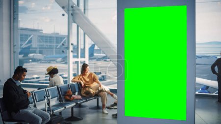 Photo for Airport Terminal: Green Screen Advertising Billboard. Arrival Departure Display with Chroma Key. Mock-up Space. Backgrond: Crowd of People Wait for - Royalty Free Image