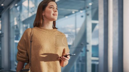 Photo for Airport Terminal: Beautiful Smiling Woman Holds Ticket, Walks Through Big Airline Hub to the Gates Where Her Airplane Waits Her. Happy Caucasian - Royalty Free Image