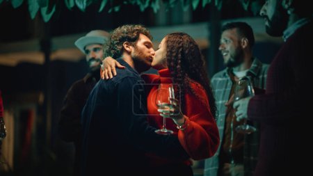 Photo for Loving Mixed Race Couple Dancing and Moving to Music at an Outdoors Terrace or Garden Party with Friends. Beautiful Man and Woman Kiss, Relax on - Royalty Free Image
