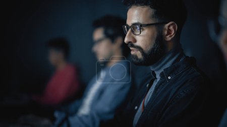 Photo for Handsome Smart Male Student, Studying in University with Diverse Multiethnic Classmates. He Works on Desktop Computer in College. Applying His - Royalty Free Image