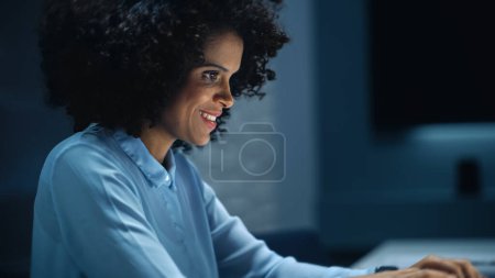 Photo for Successful African American Businesswoman Working on Laptop Computer in Big City Office Late in the Evening. Female Executive Manager Analyzing - Royalty Free Image