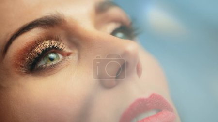 Photo for Beautiful Woman with Cosmetics Mascara to Her Lush Eyelashes. Seductive Female Enjoying Her Beauty. Portrait with Focus on Deep Brown Eyes Stylish - Royalty Free Image